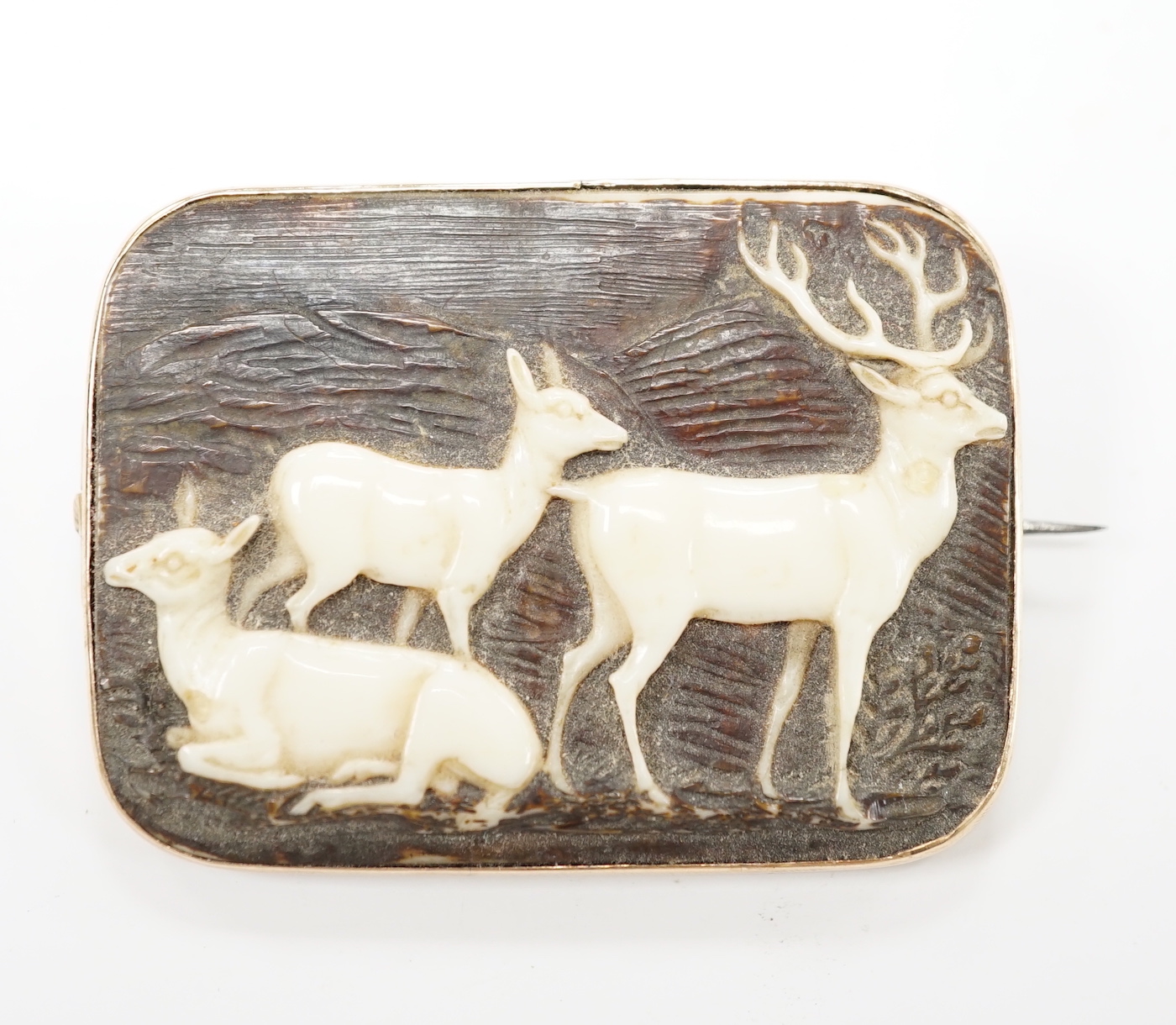 A yellow metal mounted staghorn brooch, carved with stag and deer, 48mm.